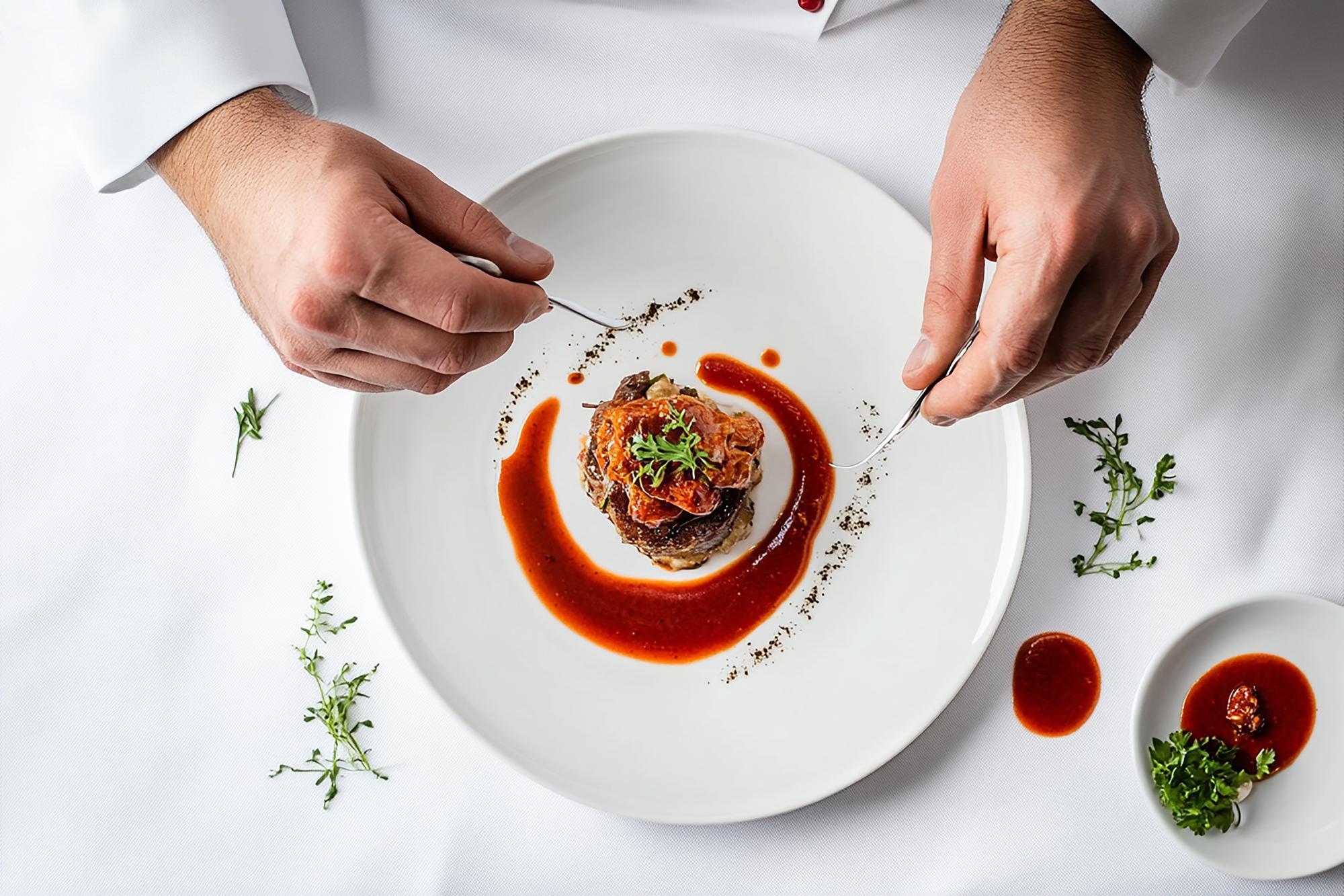 chef arranging plated dish